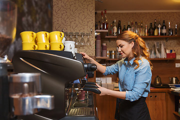 Image showing barista woman making coffee by machine at cafe