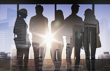 Image showing people silhouettes over city background