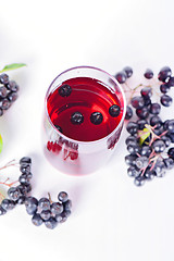 Image showing Glass of aronia juice with berries, overhead view