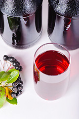 Image showing Syrup made from aronia, berries, glass and bottles