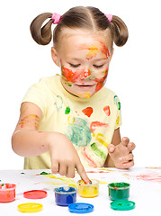 Image showing Portrait of a cute girl playing with paints