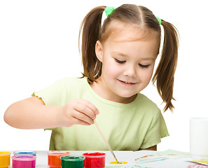 Image showing Cute cheerful child play with paints