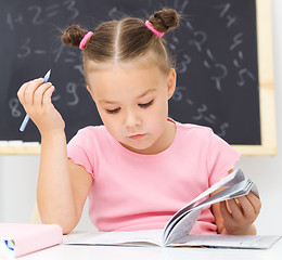 Image showing Little girl is studying