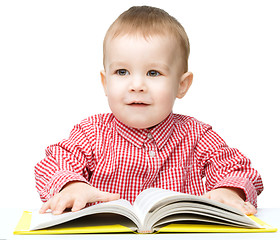 Image showing Little child play with book