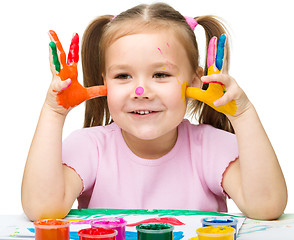 Image showing Portrait of a cute girl playing with paints