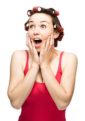 Image showing Woman is holding her face in astonishment