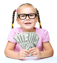 Image showing Little girl is counting dollars