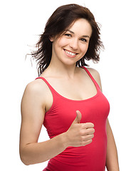 Image showing Woman is showing thumb up gesture