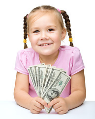 Image showing Little girl with dollars