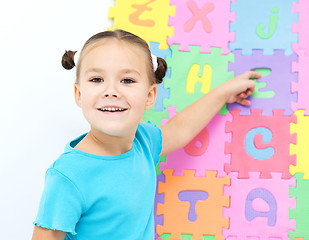 Image showing Little girl is pointing at letter Z on alphabet