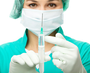 Image showing Young nurse is preparing syringe for injection