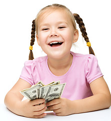 Image showing Little girl with dollars