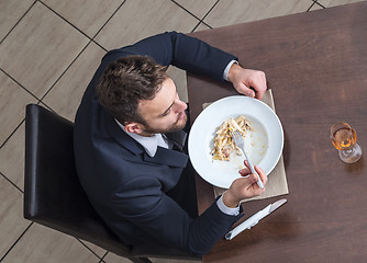 Image showing Man Eating Penne Pasta