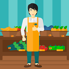 Image showing Supermarket worker with box full of apples.