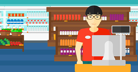 Image showing Salesman standing  at checkout.