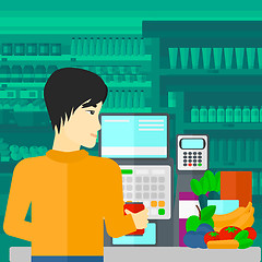 Image showing Cashier at supermarket checkout.