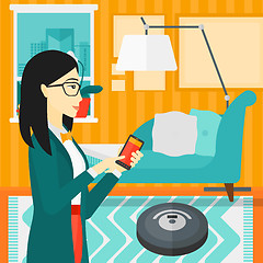 Image showing Woman with robot vacuum cleaner.