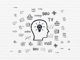 Image showing Advertising concept: Head With Lightbulb on wall background