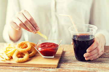 Image showing close up of woman with snacks and cocacola