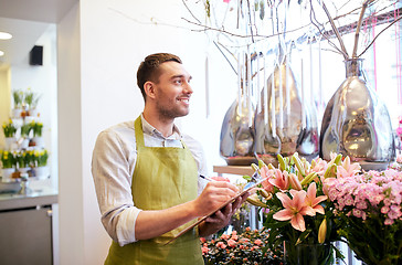 Image showing florist man with clipboard at flower shop