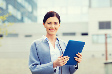 Image showing smiling business woman with tablet pc in city