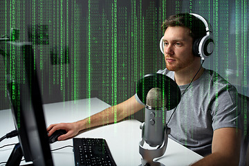 Image showing man in headset playing computer video game at home