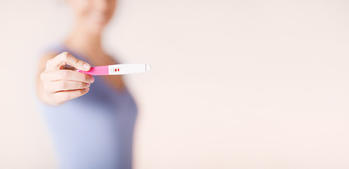 Image showing happy woman with pregnancy test