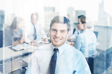 Image showing group of smiling businesspeople meeting in office