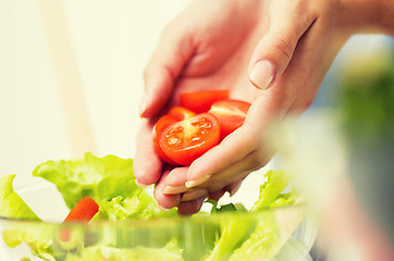 Image showing close up of woman cooking vegetable salad at home