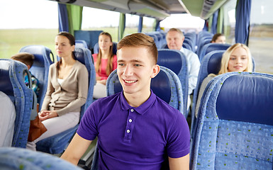 Image showing happy young man sitting in travel bus or train