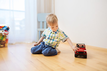 Image showing little baby boy toy playing with car at home