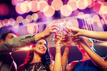 Image showing smiling friends with glasses of champagne in club