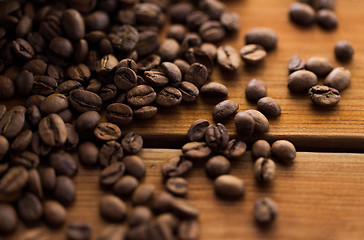 Image showing close up coffee beans on wooden table