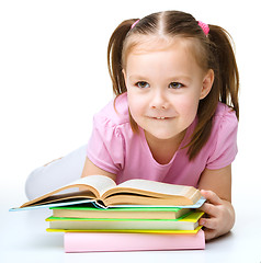 Image showing Little girl is reading a book