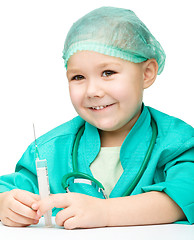 Image showing Cute little girl is playing doctor with syringe