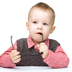 Image showing Little child play with book