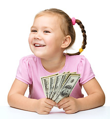 Image showing Little girl with dollars