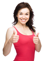 Image showing Woman is showing thumb up gesture