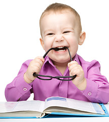 Image showing Little child play with book