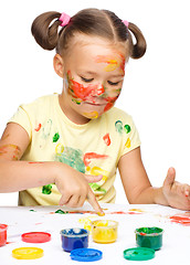 Image showing Portrait of a cute girl playing with paints