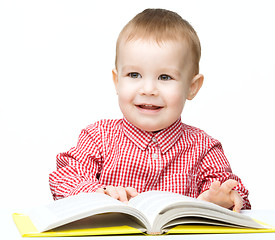 Image showing Little child play with book