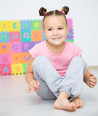 Image showing Little girl is sitting on floor in preschool