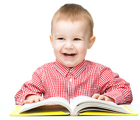 Image showing Little child play with book