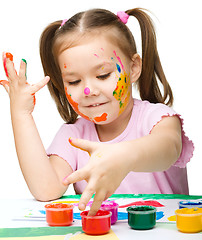 Image showing Portrait of a cute girl playing with paints