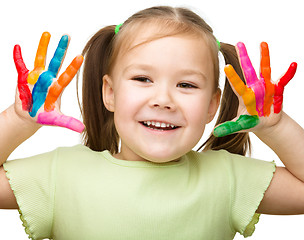 Image showing Portrait of a cute girl playing with paints