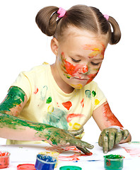 Image showing Portrait of a cute girl playing with paints