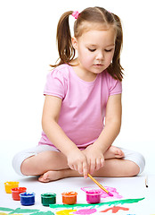 Image showing Cute cheerful child play with paints