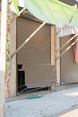 Image showing The broken shutters in a street vandals seaside shop