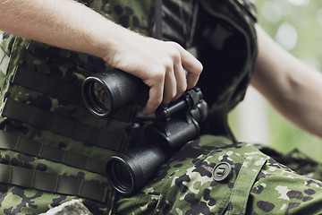 Image showing close up of soldier or hunter with binocular