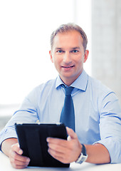Image showing businessman with tablet pc in office